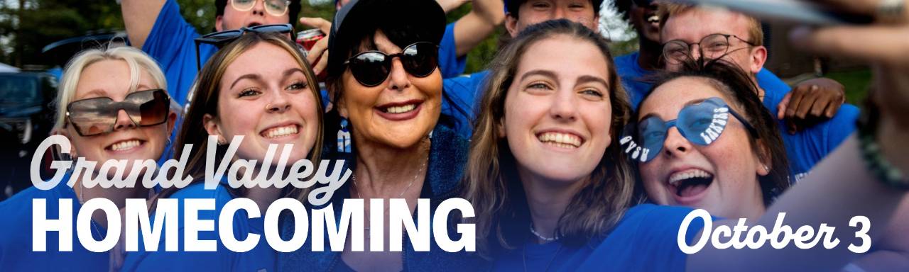 President Mantella smiles with students with text Grand Valley Homecoming October 3